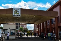 FILE - Truck drivers queue as they wait to go through Uganda's immigration office in Malaba, a city bordering with Kenya, in Uganda, April 29, 2020. (AFP)