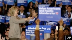 Democratic presidential candidate Hillary Clinton, left, is welcomed by Rep. Judy Chu, D-Calif., before addressing Asian American and Pacific Islander supporters in San Gabriel, Calif., Thursday, Jan. 7, 2016. (AP Photo/Damian Dovarganes)