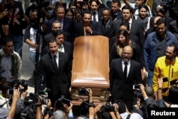 People carry the coffin of the opposition lawmaker Fernando Alban during a ceremony at the National Assembly in Caracas, Venezuela, Oct. 9, 2018.