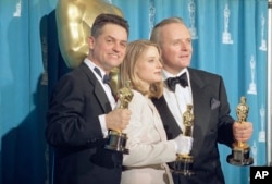 Director Jonathan Demme, left, stands with actress Jodie Foster and actor Anthony Hopkins, May 31, 1992, in Los Angeles at the Academy Awards. All three won top honors for "Silence of the Lambs," which took best picture award.