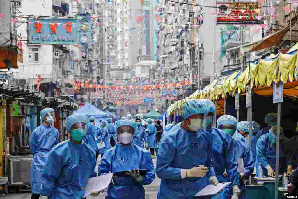 Health workers are seen in protective gear inside a locked down portion of the Jordan residential area to contain the COVID-19 in Hong Kong, Jan. 23, 2021.