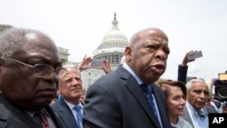 FILE - Rep. John Lewis, D-Ga., third from left, accompanied by fellow lawmakers, speaks on Capitol Hill in Washington , June 23, 2016.