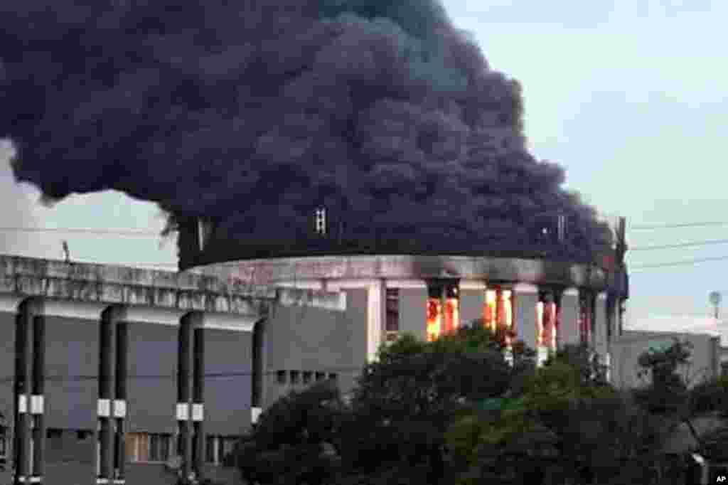 Smoke rises from the parliament building following a protest by opposition in Monrovia, Liberia.