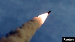 A missile is fired during the test of a multiple rocket launcher in this undated photo released Aug. 25, 2019, by North Korea's Korean Central News Agency.