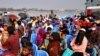 FILE - Rohingyas sit onboard a ship as they move to Bhasan Char island near Chattogram, Bangladesh, Dec. 4, 2020. 