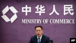 Gao Feng, spokesman for China's Ministry of Commerce, speaks during a late-night press conference about a China-Europe investment deal at the Ministry of Commerce in Beijing, Dec. 30, 2020. 