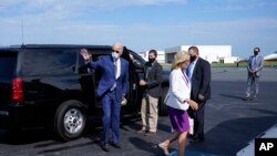 Democratic presidential candidate former Vice President Joe Biden, and his wife Jill Biden walk to board a plane at New Castle Airport, in New Castle, Del., Sept. 3, 2020, en route to Kenosha, Wis.