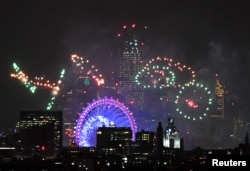 Fireworks light up the sky around the London Eye wheel to welcome the New Year in London, Britain, Jan. 1, 2019.