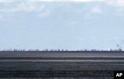 FILE - The alleged on-going reclamation of Subi Reef by China is seen from Pag-asa Island in the Spratly Islands in the South China Sea, western Palawan Province, Philippines, May 11, 2015.