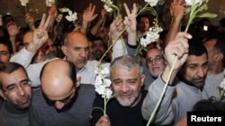 Iranians released by Syrian rebels arrive at a hotel in Damascus, Syria, January 9, 2013. 