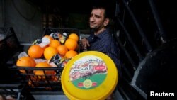 A vendor displays a box of Iranian dates in Baghdad, Iraq, March 14, 2018. 