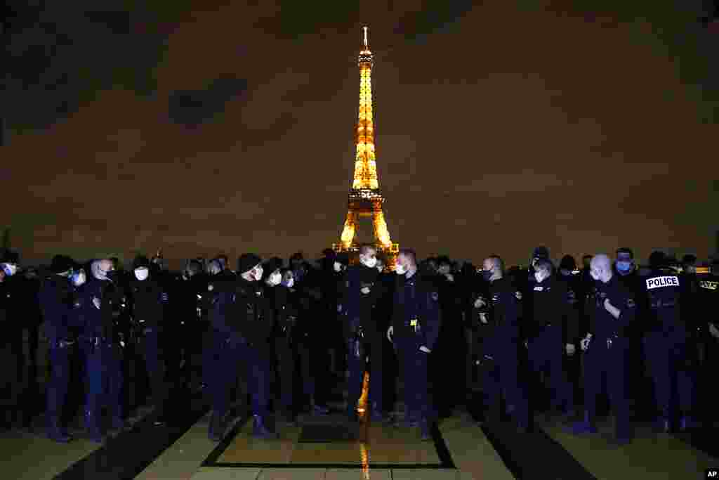 French police officers gather on the Trocadero square in front of the Eiffel Tower to protest against their working conditions, in Paris.