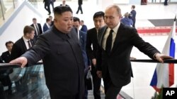 Russian President Vladimir Putin, right, and North Korea's leader Kim Jong Un take an elevator heading to the talks in Vladivostok, Russia, Thursday, April 25, 2019. Putin and Kim are set to have one-on-one meeting at the Far Eastern State…