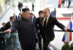 FILE - Russian President Vladimir Putin and North Korea's leader Kim Jong Un take an escalator to the talks in Vladivostok, Russia, April 25, 2019.
