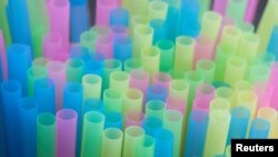 FILE - Drinking straws protrude from a glass in a illustration picture in Loughborough, Britain, April 19, 2018. 