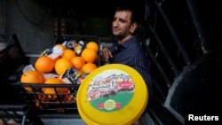 A vendor displays a box of Iranian dates in Baghdad, Iraq, March 14, 2018. 