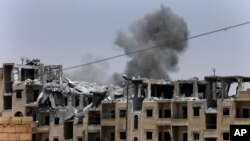 Smoke rises from a coalition airstrike which attacked an Islamic State position, on the front line on the western side of Raqqa, northeast Syria, July 17, 2017.