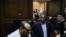 FILE - Investigative journalist Hossam Baghat, center, leaves a courtroom at the Cairo Criminal Court after the court postponed a decision on whether to implement an order to freeze his assets over allegations of illegal foreign funding, in Cairo, Egypt, March 2