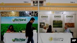 A visitor walks by U.S. soybean companies' booths at the international soybean exhibition in Shanghai, China, April 12, 2018.