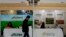A visitor walks by U.S. soybean companies' booths at the international soybean exhibition in Shanghai, China, April 12, 2018.