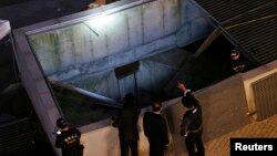 At least 14 concert-goers were killed in Seongnam, South Korea, when a ventilation shaft’s grate on which they were standing collapsed. Police officials inspect the scene Oct. 17, 2014.