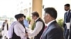 Pakistan's Foreign Minister Shah Mehmood Qureshi welcomes Mullah Abdul Ghani Baradar, who a leading Taliban delegation, upon his arrival at the Ministry of Foreign Affairs, in Islamabad, Pakistan, Oct. 3, 2019.