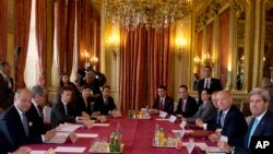 French Foreign Minister Laurent Fabius, left, U.S. Secretary of State John Kerry, right, and British Foreign Secretary William Hague, second right, pose for the media prior to a meeting on Syria at the Quai d'Orsay in Paris, Sept. 16, 2013.