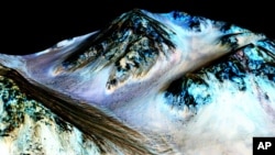 This undated photo provided by NASA and taken by an instrument aboard the agency's Mars Reconnaissance Orbiter shows dark, narrow, 100-meter-long streaks on the surface of Mars that scientists believe were caused by streams of salt water.  (NASA / J