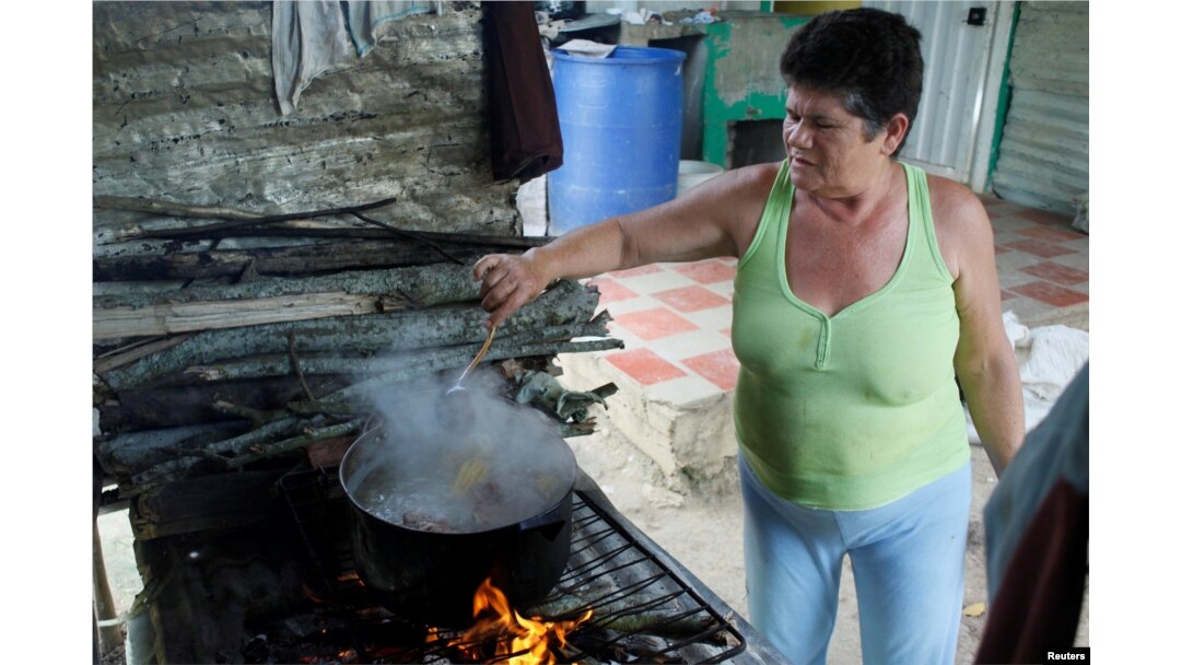 Margarita Rojas memasak dengan kayu bakar di rumahnya di San Cristobal, Venezuela, 5 Agustus 2017