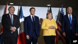 From left, British Prime Minister Boris Johnson, French President Emmanuel Macron, German Chancellor Angela Merkel and U.S. President Joe Biden pose for a photo at the G-20 summit in Rome, Italy, Oct. 30, 2021.