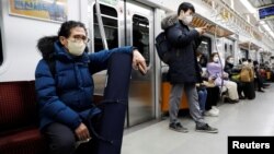 Park Gyung-sun rides on a subway to deliver a parcel in Seoul, South Korea, Feb. 8, 2023.