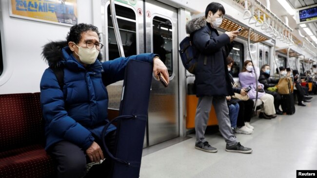 Park Gyung-sun rides on a subway to deliver a parcel in Seoul, South Korea, Feb. 8, 2023.