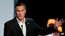 Former Republican presidential nominee Mitt Romney introduces Republican U.S. Rep. Mia Love, of Utah, during a campaign rally, Aug. 24, 2018, in Lehi, Utah.