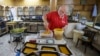 Hasan El-Makary weighs mufataka, a traditional Beiruti sweet, at his shop in the Lebanese capital on Aug. 29, 2024. 