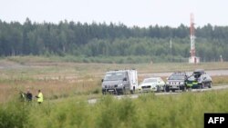 Police officers stand close to the accident site to investigate the plane wreck outside Orebro Airport on July 9, 2021, where all nine people aboard a small aircraft used for skydiving that crashed had died.