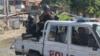 Police officers patrol an area during an exchange of gunfire between gangs and police in Port-au-Prince, Haiti, Nov. 11, 2024. 