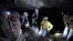 FILE - In this Jan. 13, 2015 file photo, Joe Main, third from left, Assistant Secretary of Labor for Mine Safety and Health, and Patricia Silvey, center, Deputy Assistant Secretary for Operations with MSHA, speak with workers at the Gibson North mine, in Princeton, Indiana. 