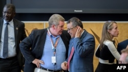 FILE - World Health Organization director-general Tedros Adhanom Ghebreyesus, right, listens to WHO emergencies chief Mike Ryan during a meeting of the United Nations.