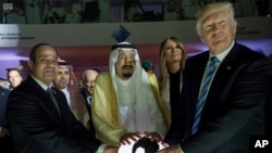 FILE - In this May 21, 2017 photo released by the Saudi Press Agency, from left to right, Egyptian President Abdel Fattah al-Sissi, Saudi King Salman, U.S. First Lady Melania Trump and President Donald Trump, visit a new Global Center for Combating Extrem