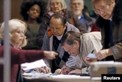 FILE - Precinct 5 Democratic Farm Labor Party voters register to take part in Super Tuesday caucusing for delegates at the Folwell Community Center Democratic caucus location in Minneapolis, Minnesota, March 1, 2016.