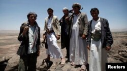 FILE - Pro-government tribesmen stand on a mountain where they are positioned to guard their area amid tension with militants of the Shiite Houthi group near Amran city, the capital of Amran province, north of the Yemeni capital, Sanaa, April 12, 2014.