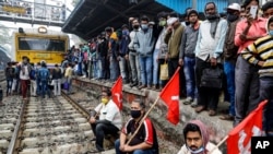 Left party supporters black a railway track during a nationwide shutdown called by thousands of Indian farmers protesting new agriculture laws in Kolkata, India, Dec. 8, 2020. 