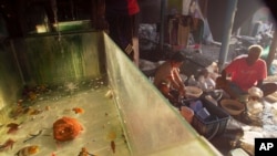 Workers sort fish at a middle man house in Les, Bali, Indonesia, April 11, 2021.