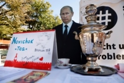 GERMANY -- A mock offer of "Novichok Tea" is seen in front of an effigy of Russian President Vladimir Putin outside the Russian embassy in Berlin, September 23, 2020.