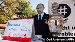 GERMANY -- A mock offer of "Novichok Tea" is seen in front of an effigy of Russian President Vladimir Putin outside the Russian embassy on Unter den Linden in Berlin, Sept. 23, 2020.