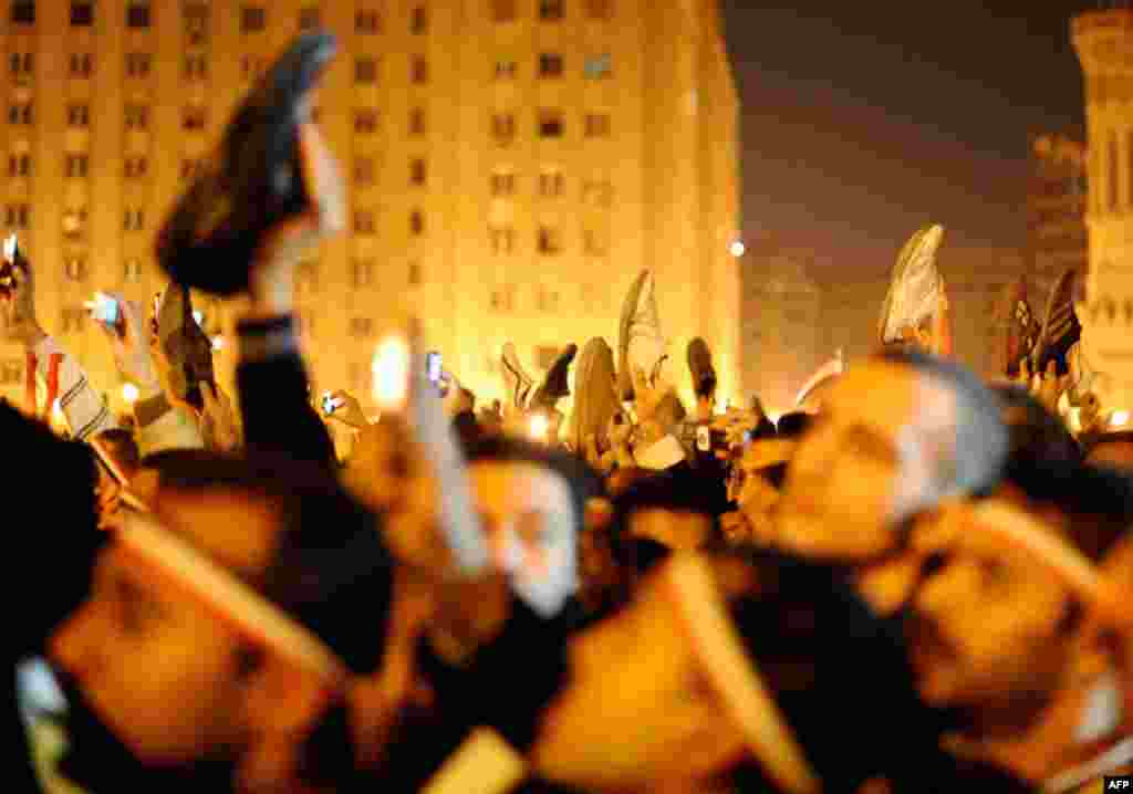 Protesters wave shoes in dismay as President Hosni Mubarak speaks to the nation. (Reuters/Dylan Martinez)