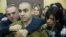 FILE - Israeli solider Sgt. Elor Azaria waits with his parents for the verdict inside the military court in Tel Aviv, Israel on Jan. 4, 2017. 
