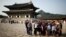 FILE - Chinese tourists pose for a group photo at the Gyeongbok Palace in central Seoul, South Korea, Oct. 5, 2016. The number of Chinese tourists visiting South Korea fell 20 percent in March.