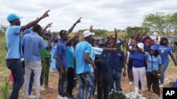 FILE —Opposition supporters chant party slogans at the burial of Moreblessing Ali, on the outskirts of Harare, March, 2, 2024.