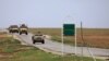 FILE - U.S. military vehicles are seen near Hasakah, Syria, Nov. 4, 2018.